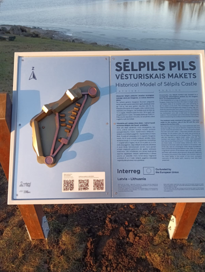 Stends pretī Sēlpils pilsdrupām